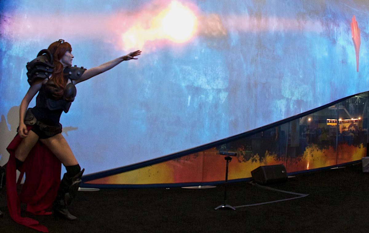 A woman in costume flows a virtual flame as part of a brand activation at a comic book festival