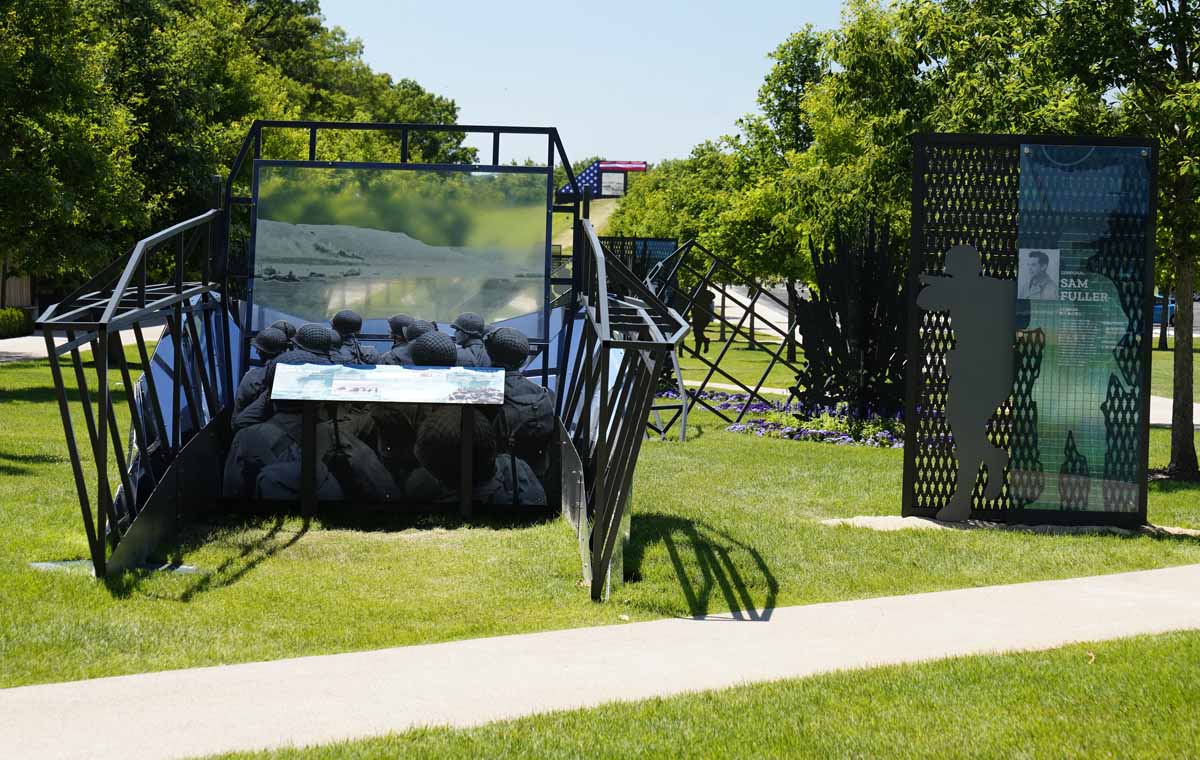 The museum graphics at the First Division Museum's D-Day exhibit use semi-translucent images to create an analog AR experience