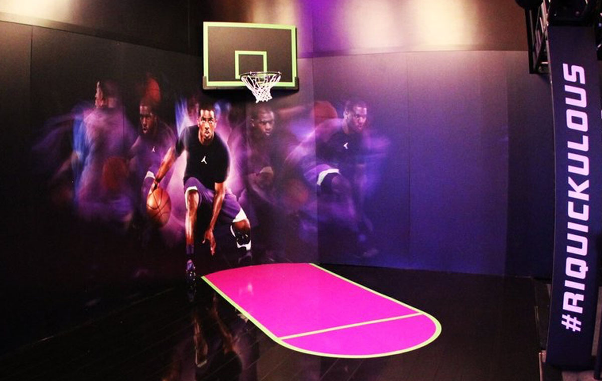 A Nike interactive retail display allows customers to try out shoes on the court.